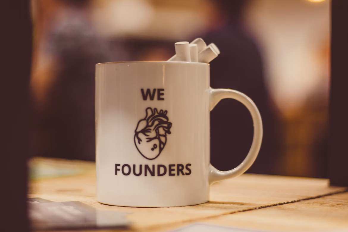 We love founders mug on a warm workspace